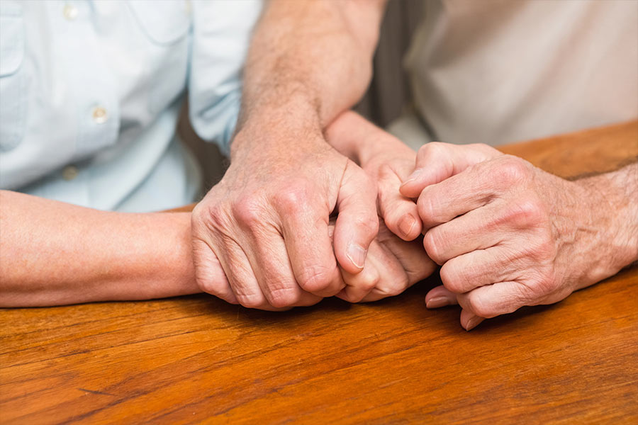 Elderly couple holding hands after unattended death consultation for clean up services in Fairfax, VA